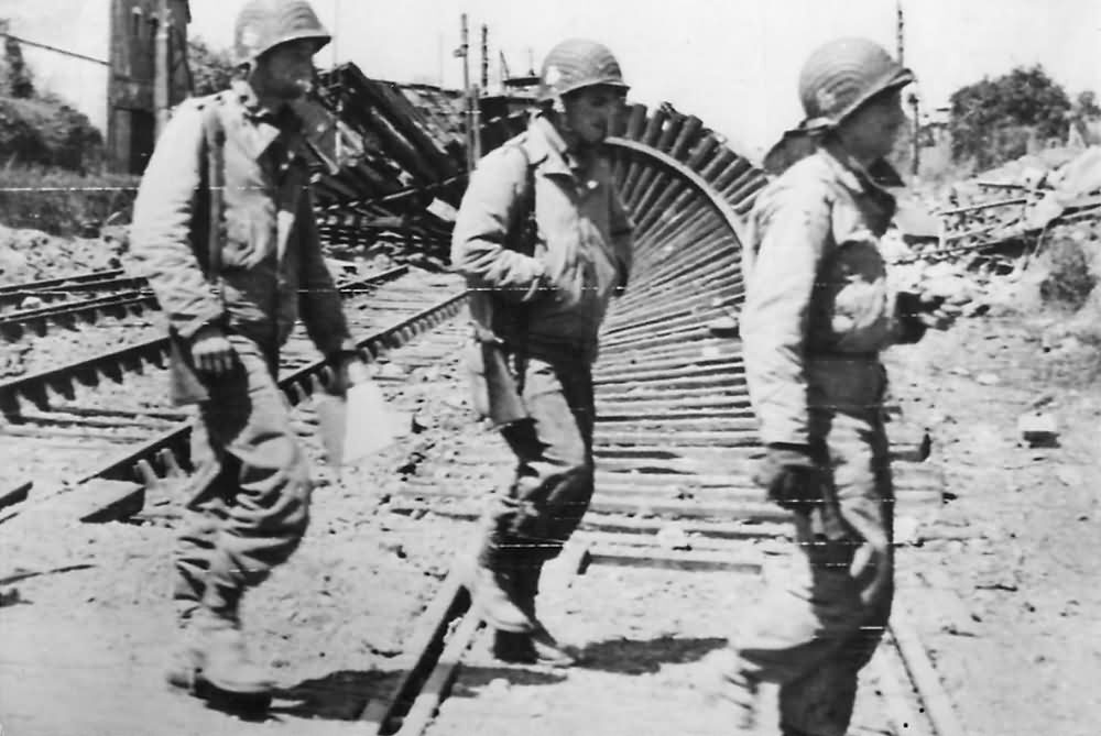 Soldiers_of_327th_Glider_Infantry_Regiment_amid_Ruins_of_Carentan_1944_Normandy